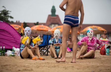 Sunbathers in masks