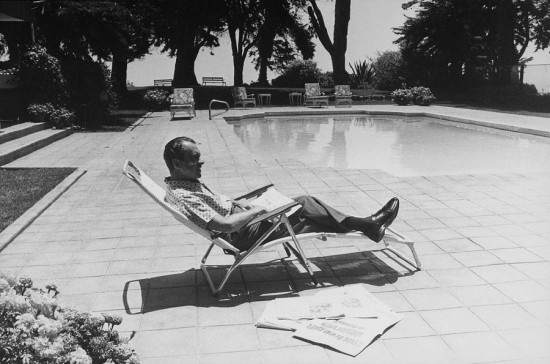 Richard Nixon, at home reading newspapers.